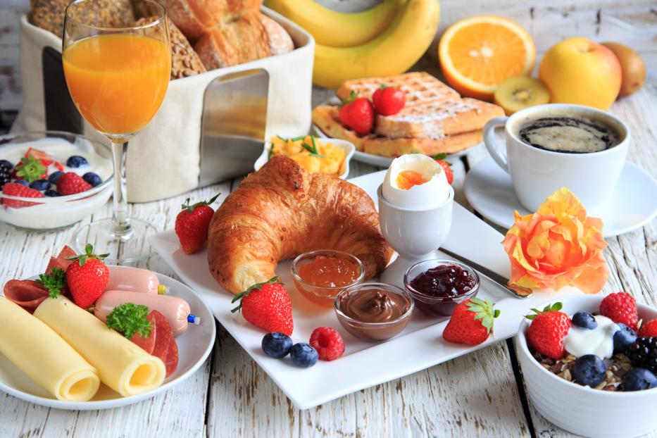 rich breakfast on wooden table