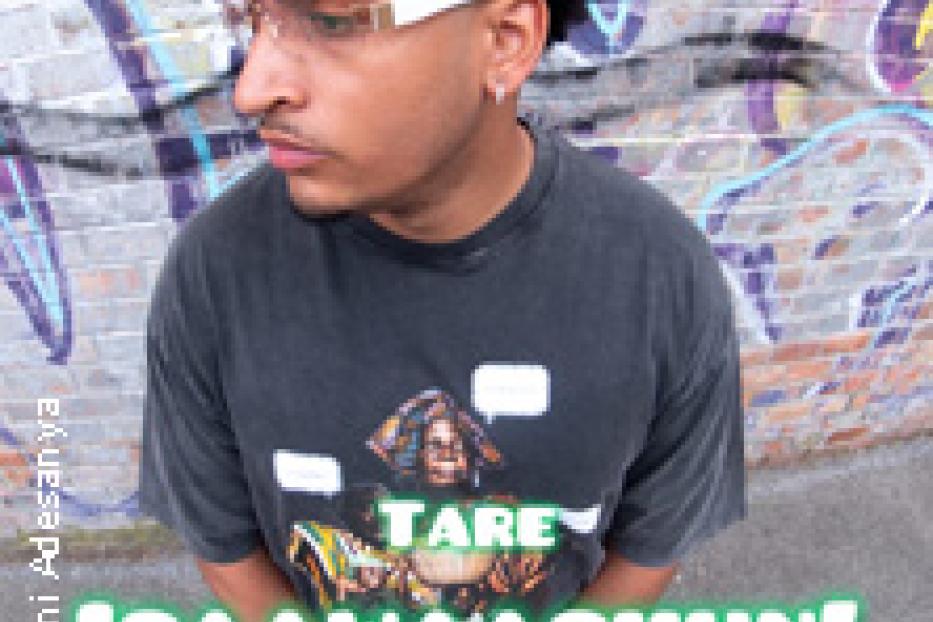 Ein junger Mann mit Sonnenbrille und T-Shirt posiert vor einer Graffiti-Wand.