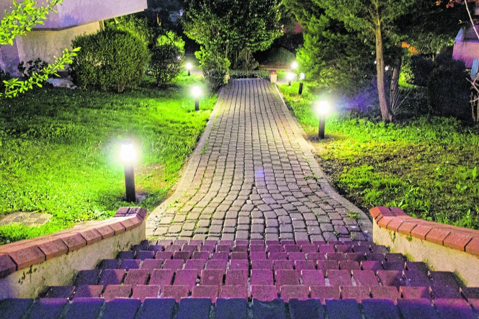 House and garden in city at midnight