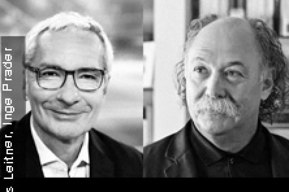 Schwarz-Weiß-Porträt von zwei Männern, einer mit Brille und der andere mit Schnurrbart.