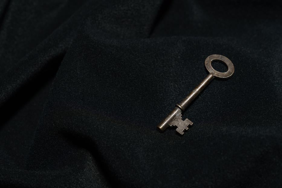 Vintage key on black background
