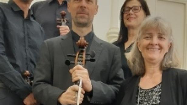 Fünf Musiker posieren mit ihren Instrumenten für ein Gruppenfoto.