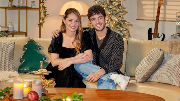 Christina und Luca Hänni sitzen auf Couch in weihnachtlich geschmücktem Wohnzimmer 